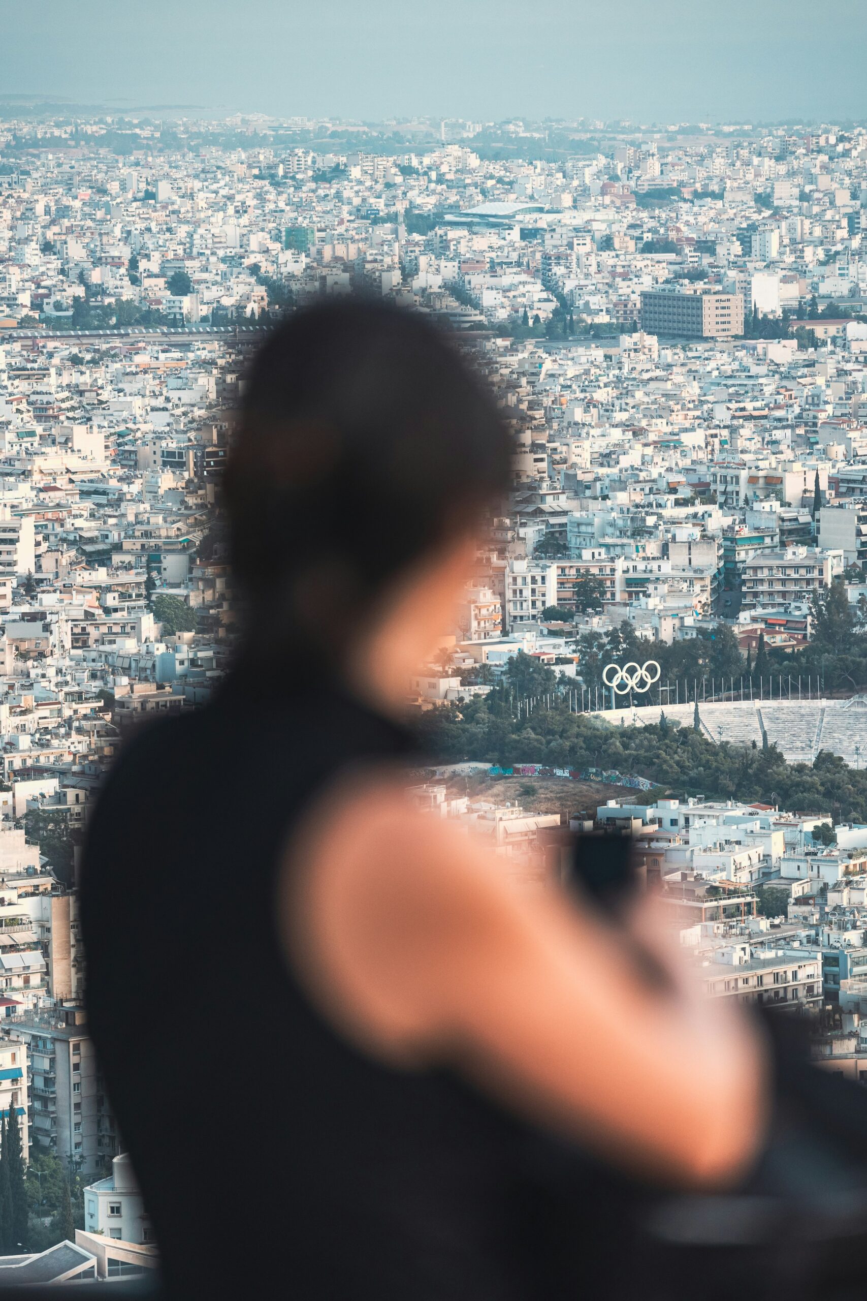 a woman standing on top of a tall building